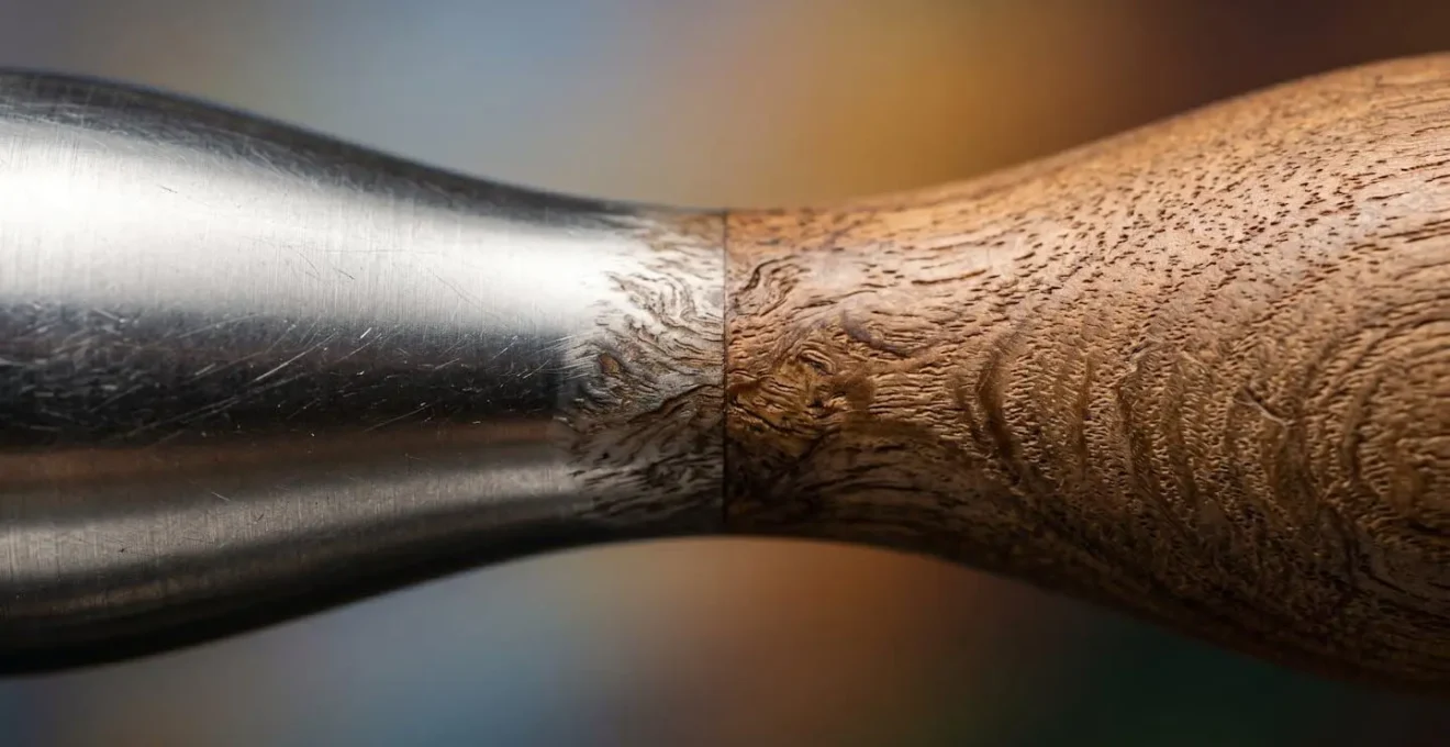 Abstract representation of a metallic surface representing STEM merging with organic wood grain representing the Humanities.